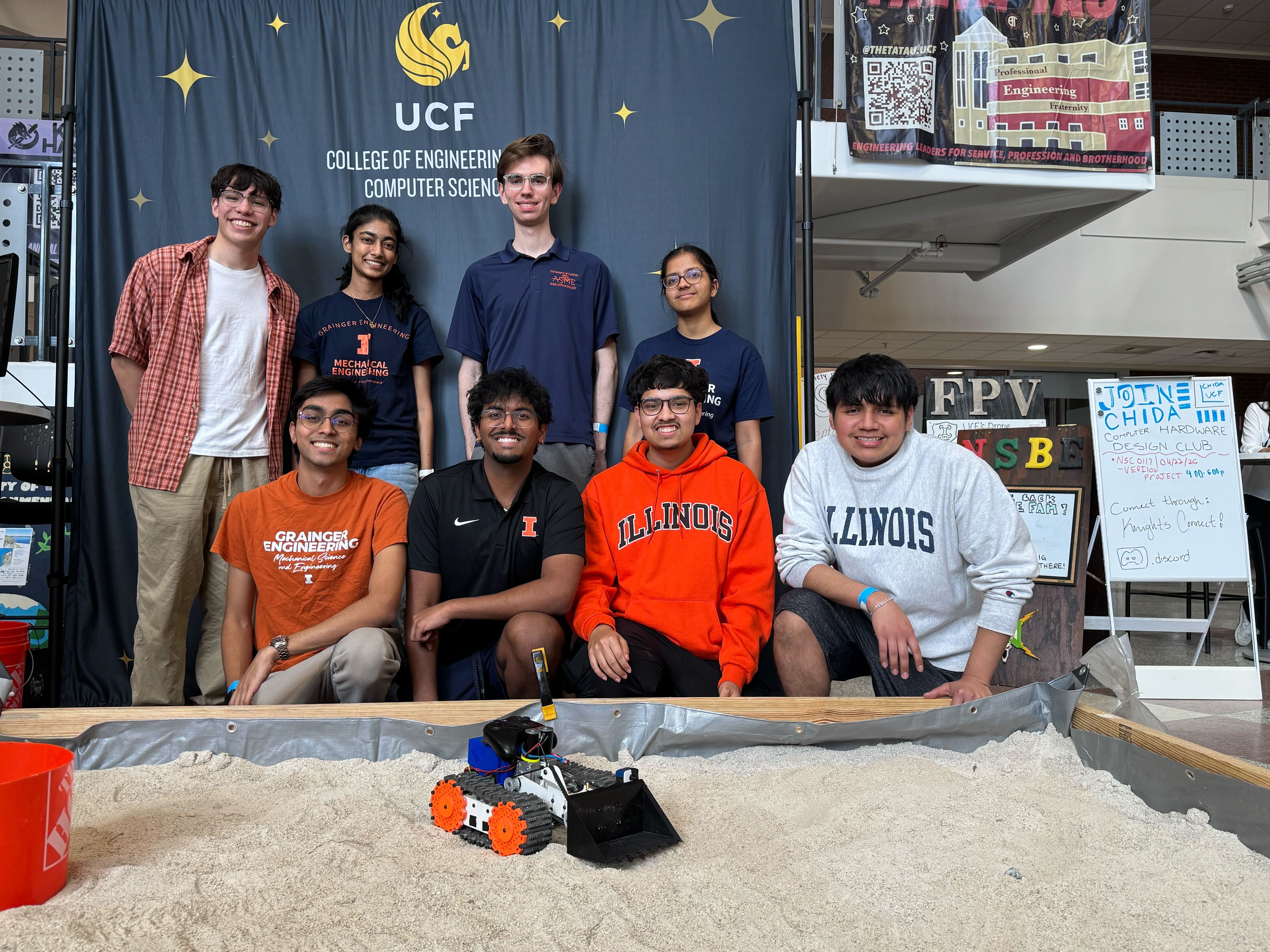 Team at UCF competition arena with rover